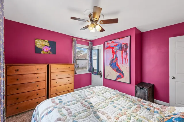 a bedroom with a bed and a dresser