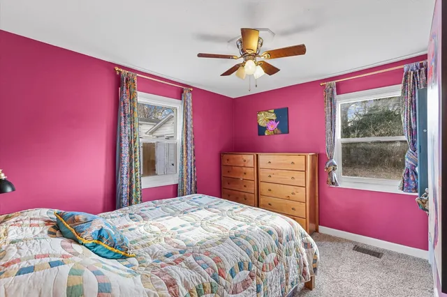 a bedroom with a bed dresser and a window