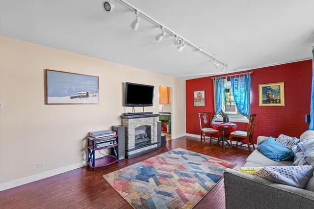 a living room with furniture a flat screen tv and a fireplace