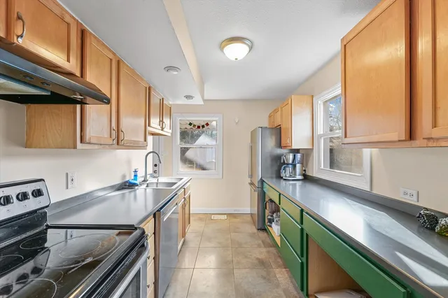 a kitchen with stainless steel appliances granite countertop a sink stove and refrigerator