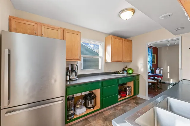 a kitchen with stainless steel appliances granite countertop a refrigerator and a sink