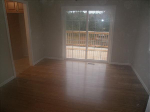 7 Beaver Path Wareham, MA 02576 - Photo 8 of 21 a view of an empty room with wooden floor and windows
