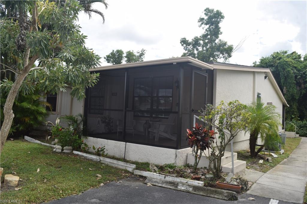 5318 Treetops Drive, Unit IG3 Naples, FL 34113 - Photo 11 of 13 a couple of potted plants in front of door