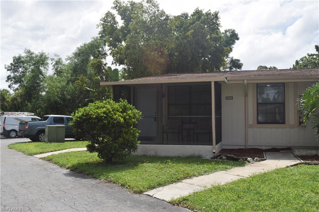 5318 Treetops Drive, Unit IG3 Naples, FL 34113 - Photo 12 of 13 a view of a house with backyard and garden