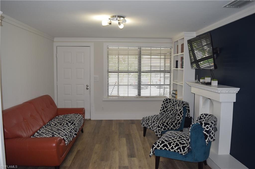 5318 Treetops Drive, Unit IG3 Naples, FL 34113 - Photo 2 of 13 a living room with furniture and a flat screen tv