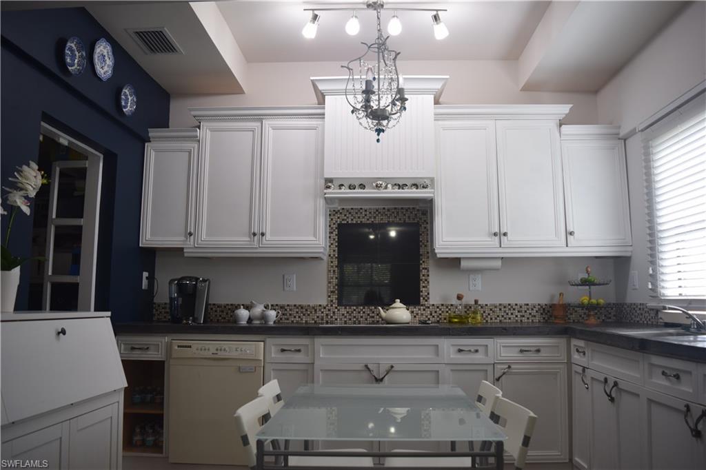 5318 Treetops Drive, Unit IG3 Naples, FL 34113 - Photo 3 of 13 a kitchen with stainless steel appliances granite countertop a stove a sink dishwasher and cabinets with wooden floor