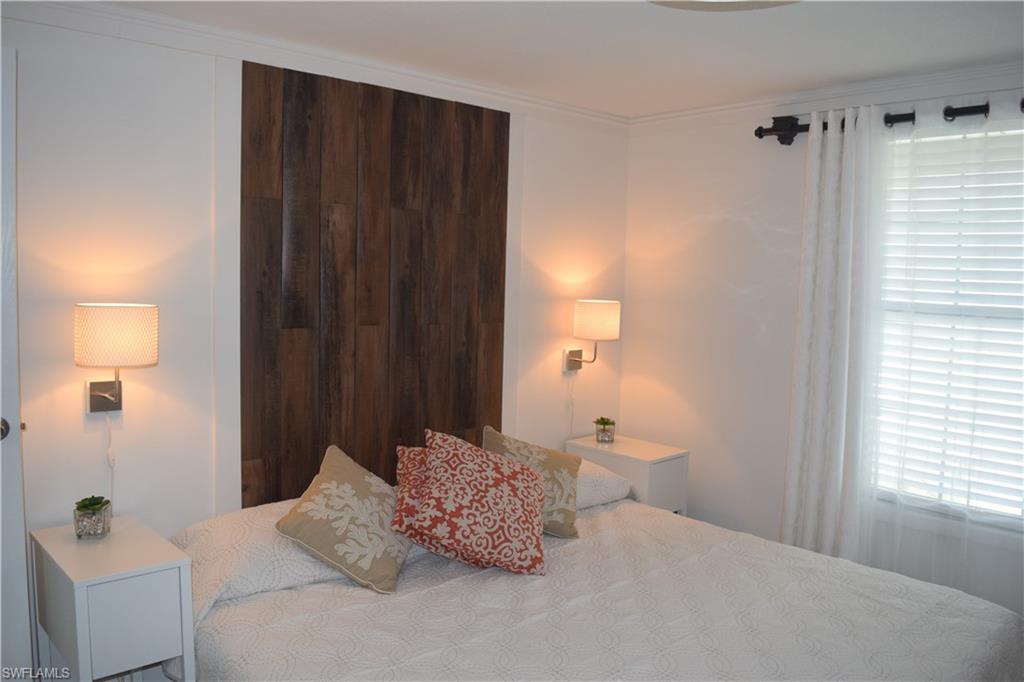 5318 Treetops Drive, Unit IG3 Naples, FL 34113 - Photo 5 of 13 a bedroom with a bed and a window