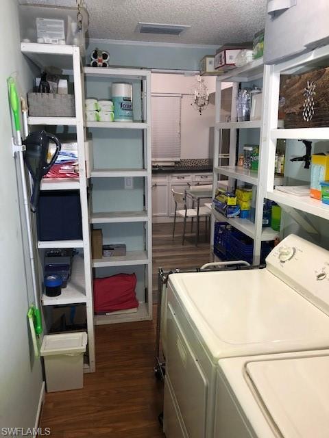 5318 Treetops Drive, Unit IG3 Naples, FL 34113 - Photo 8 of 13 a utility room with dryer washer and a view of living room