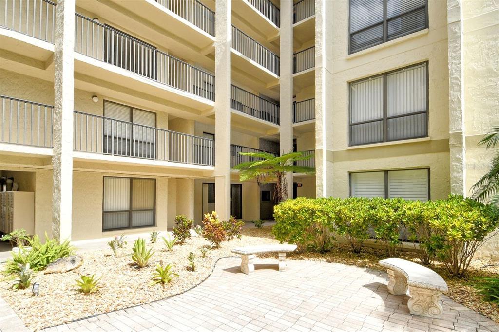 6157 Midnight Pass Road, Unit E63 Sarasota, FL 34242 - Photo 7 of 61 a view of a building with potted plants