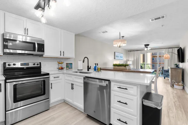 a kitchen with a sink stove and microwave