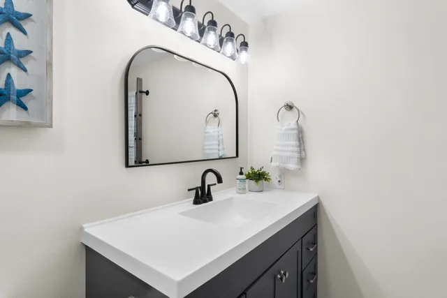 a bathroom with a sink and a mirror
