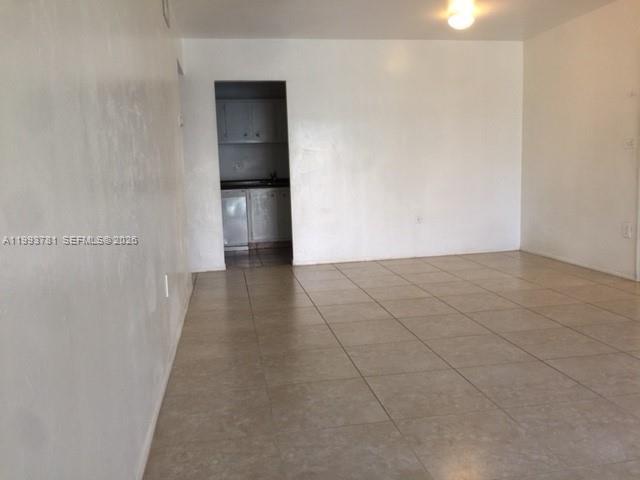 7913 Southwest 104th Street, Unit G207 Miami, FL 33156 - Photo 7 of 11 a view of an empty room with wooden floor
