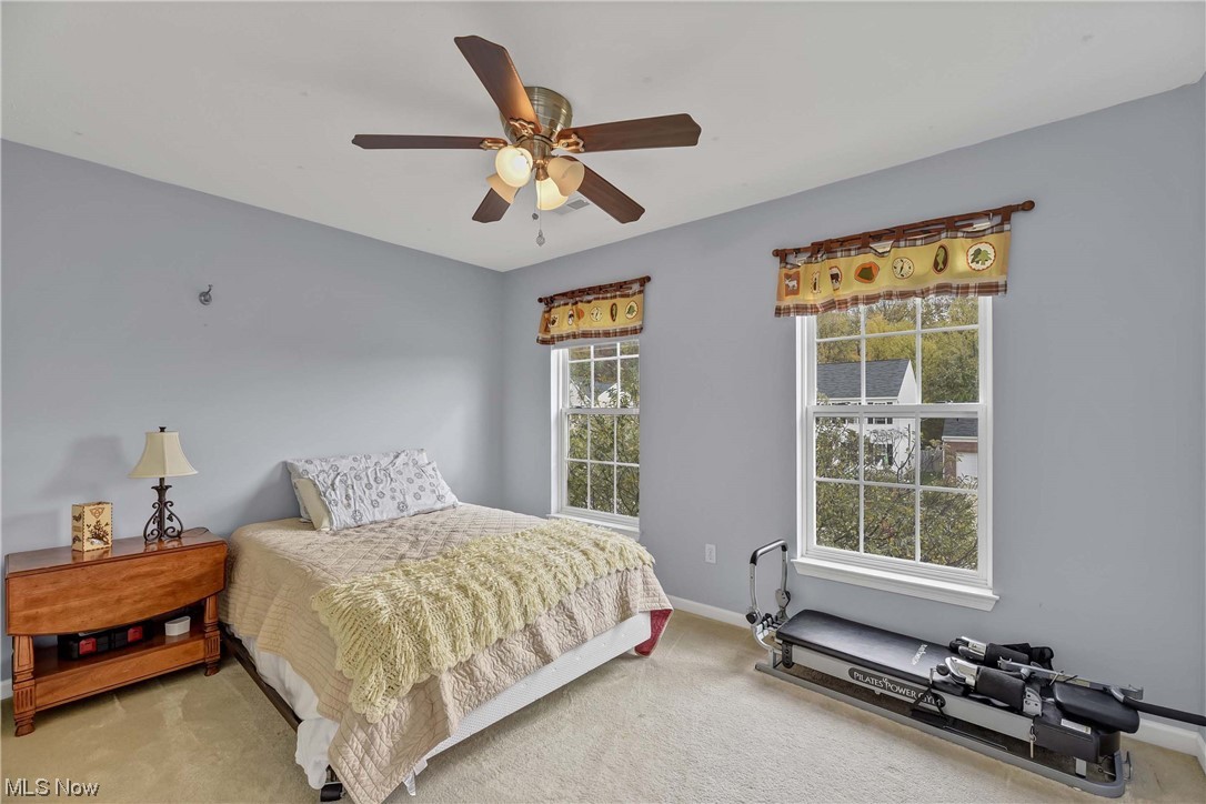 5408 Otten Road North Ridgeville, OH 44039 - Photo 20 of 33 Bedroom with light colored carpet, multiple windows, and ceiling fan