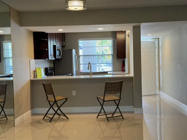 a dining room with furniture and window