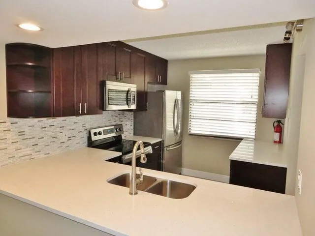 a kitchen with a refrigerator and a sink