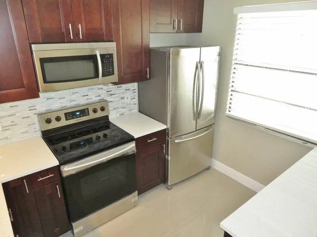 a kitchen with a refrigerator stove and microwave