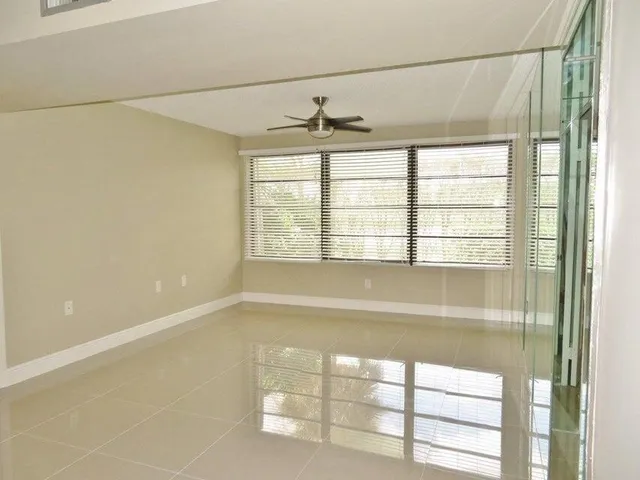 a bathroom with a window and a shower