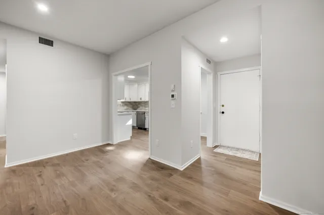 a view of a kitchen with a sink and wooden floor