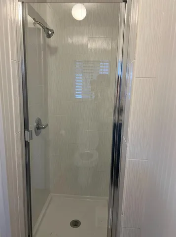 a bathroom with a glass shower door