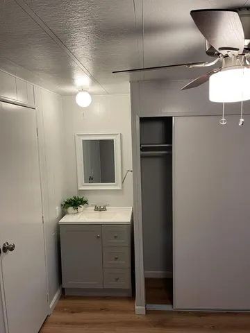 a bathroom with a sink toilet and mirror
