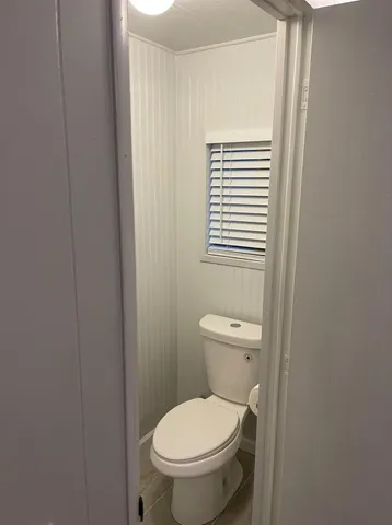 a white toilet sitting next to a bathroom sink