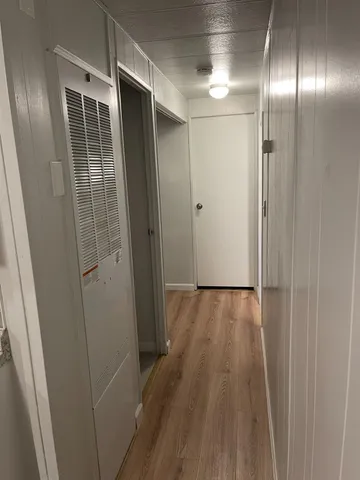 a view of hallway with wooden floor