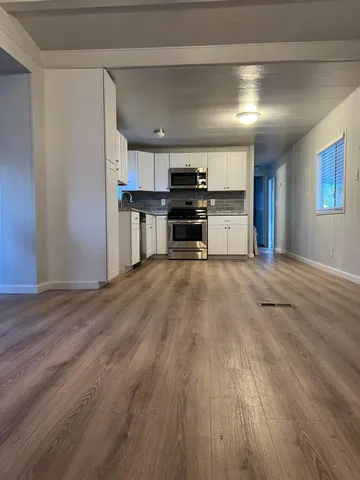 a kitchen with stainless steel appliances a refrigerator and a stove top oven