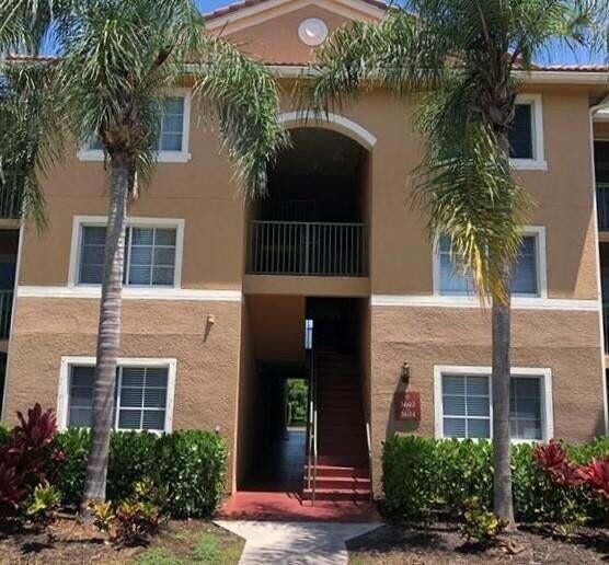 3602 Northwest Adriatic Lane, Unit 6105 Jensen Beach, FL 34957 - Photo 1 of 18 a front view of a house with plants
