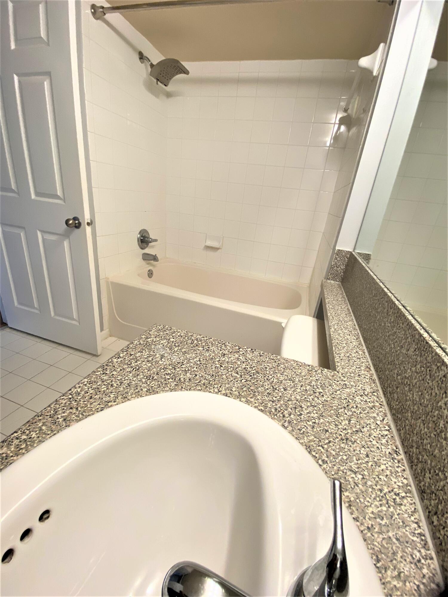 3602 Northwest Adriatic Lane, Unit 6105 Jensen Beach, FL 34957 - Photo 13 of 18 a en suite bathroom with a bathtub and shower