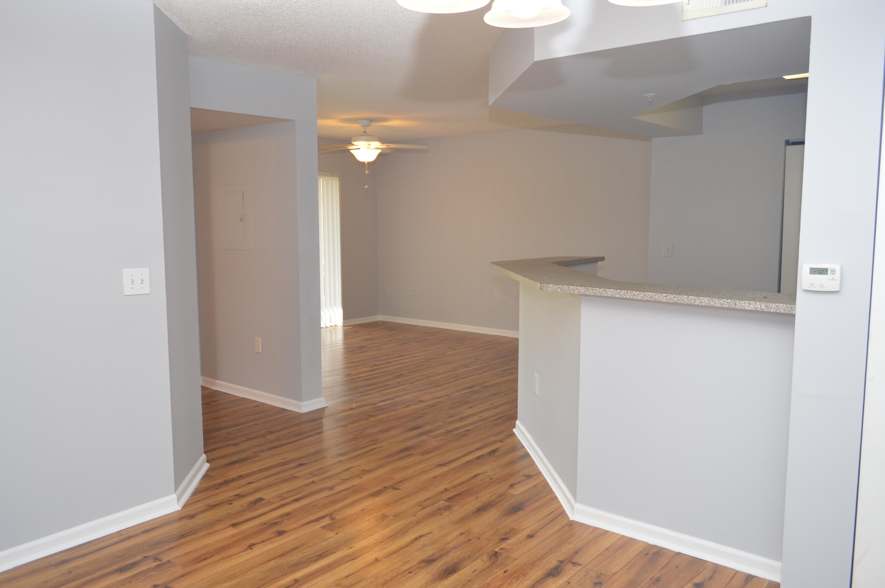 3602 Northwest Adriatic Lane, Unit 6105 Jensen Beach, FL 34957 - Photo 3 of 18 a view of a hallway with wooden floor