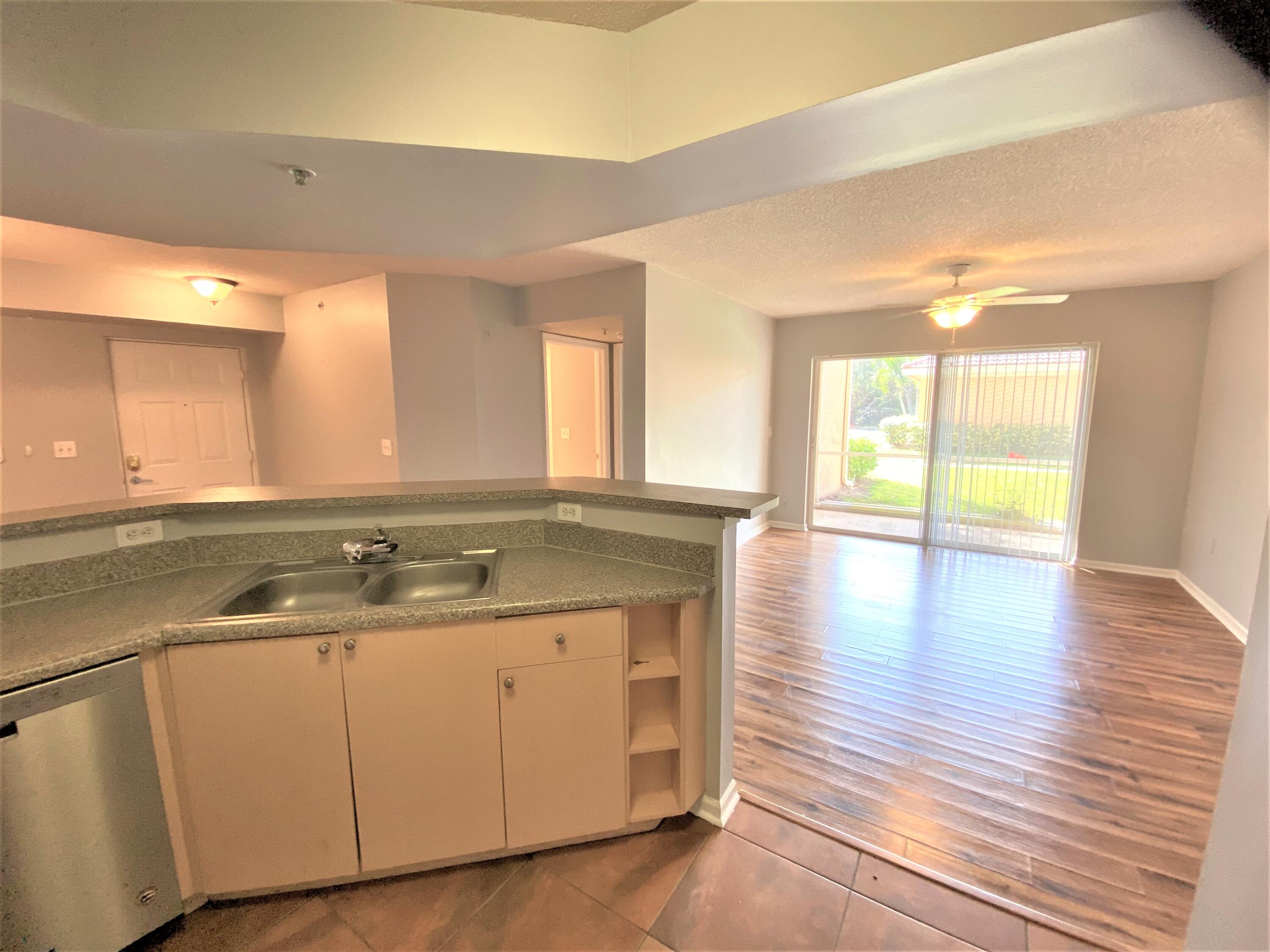 3602 Northwest Adriatic Lane, Unit 6105 Jensen Beach, FL 34957 - Photo 6 of 18 a bathroom with a granite countertop sink and a large mirror