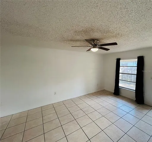 a view of an empty room and a window