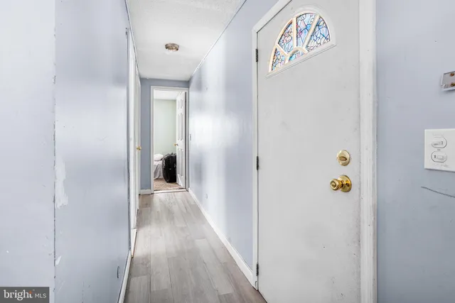 a view of hallway with wooden floor