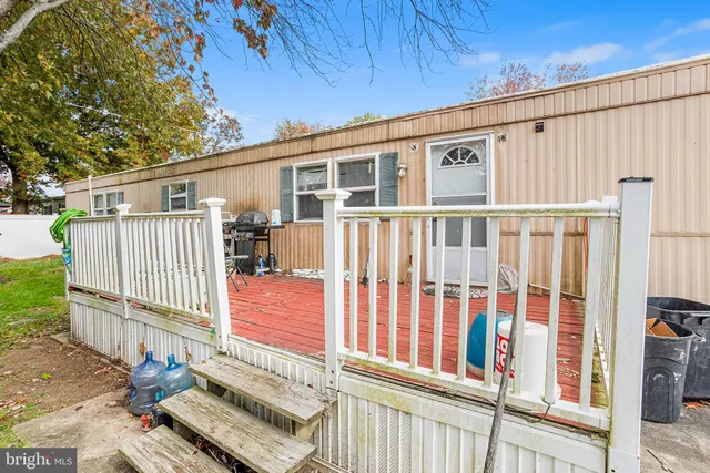 a view of a house with a small deck