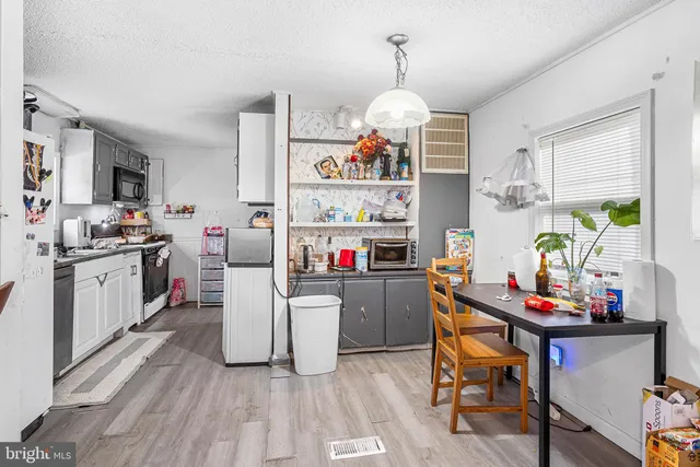 a kitchen that has a lot of cabinets a sink and a stove in it