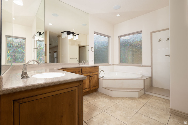 888 East Fiddlers Canyon Road Cedar City, UT 84721 - Photo 31 of 74 Full bathroom featuring double vanity, a garden tub, a stall shower, and light tile patterned flooring