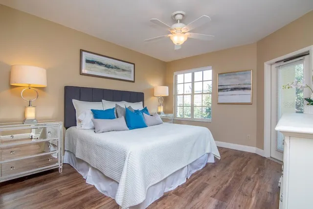 a bedroom with bed and wooden floor