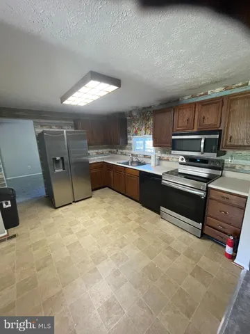 a room with a large window and furniture