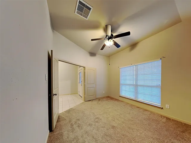 an empty room with a empty space and a ceiling fan