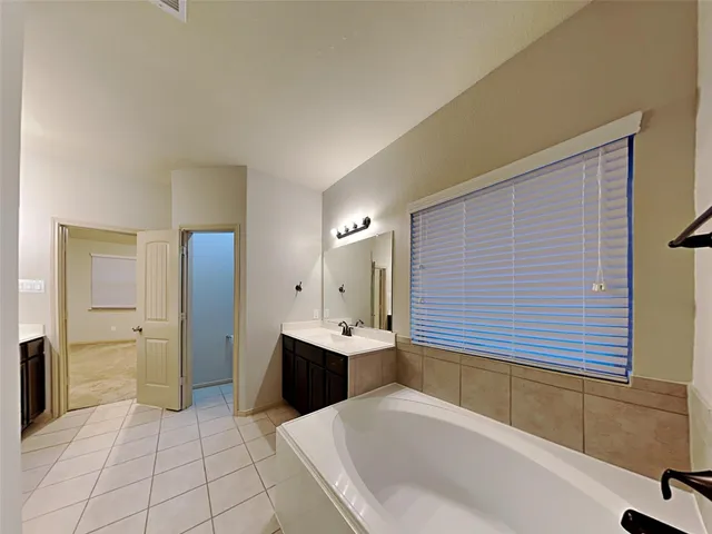 a bathroom with a bathtub and a sink