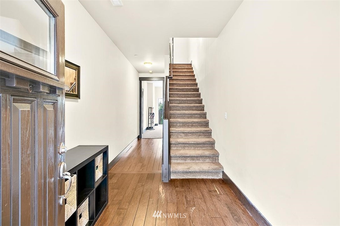 3808 Northeast 3rd Place Renton, WA 98056 - Photo 2 of 34 a view of a hallway with wooden floor and staircase