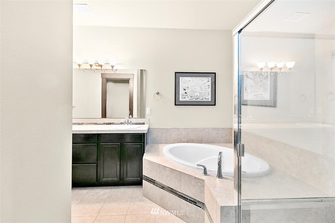 3808 Northeast 3rd Place Renton, WA 98056 - Photo 25 of 34 a bathroom with a tub a sink and a window