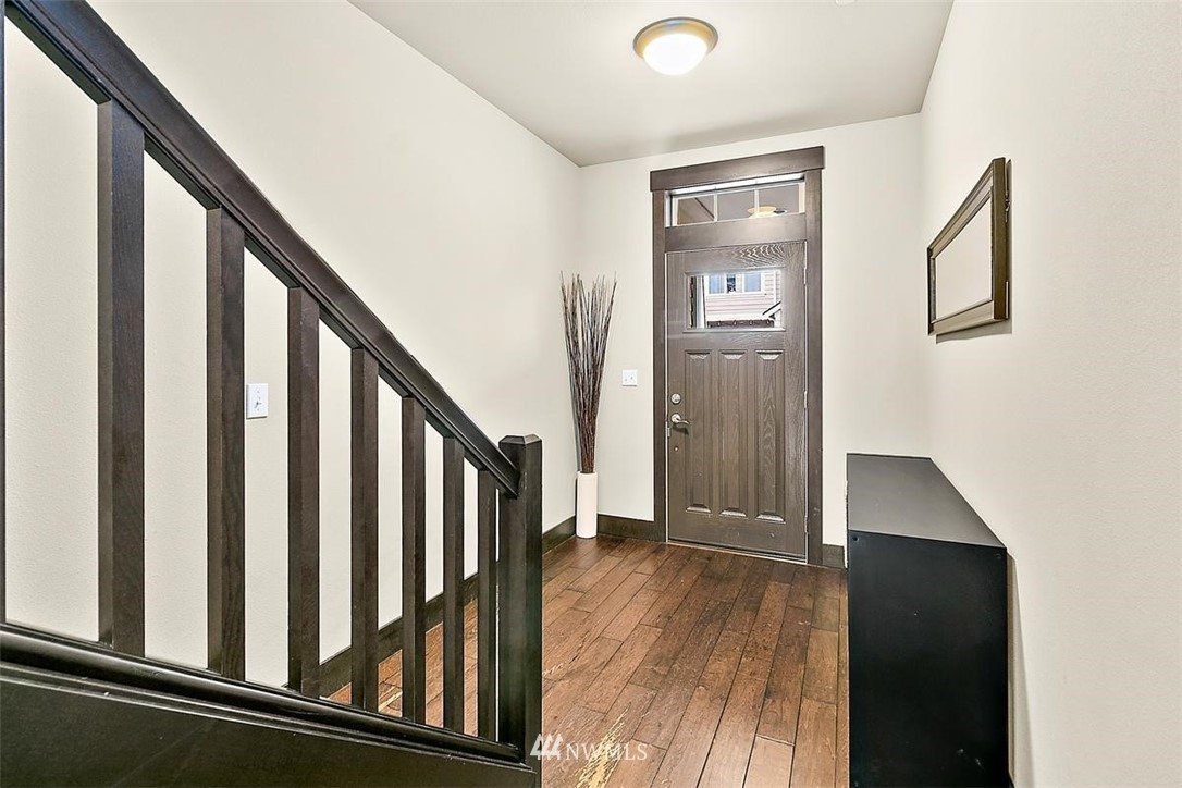 3808 Northeast 3rd Place Renton, WA 98056 - Photo 3 of 34 a view of a hallway with wooden floor and staircase
