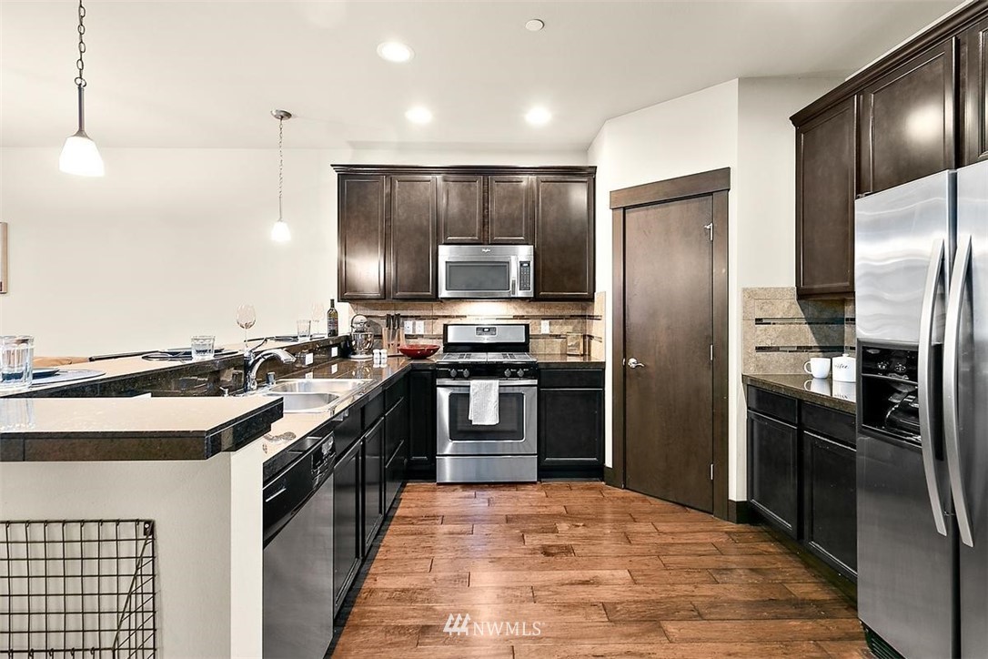 3808 Northeast 3rd Place Renton, WA 98056 - Photo 7 of 34 a kitchen with stainless steel appliances and a kitchen island