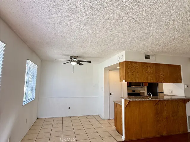 a view of kitchen with stainless steel appliances cabinets and a window