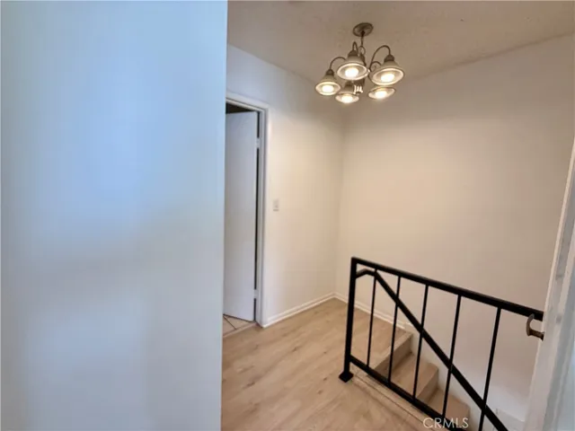 a view of a hallway with a chandelier