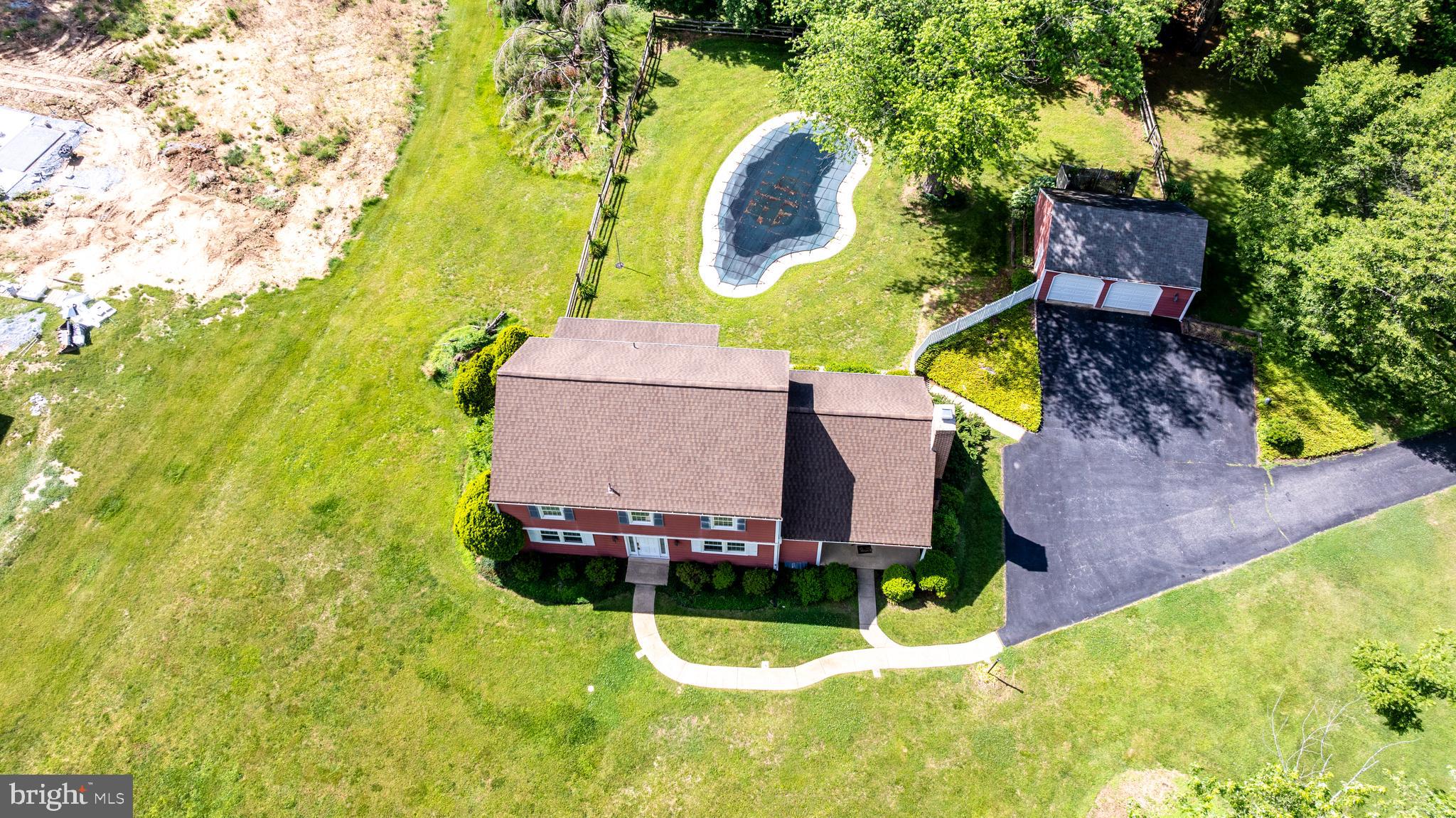 1929 Hillendale Road Chadds Ford, PA 19317 - Photo 15 of 56 an aerial view of a house with swimming pool and large trees