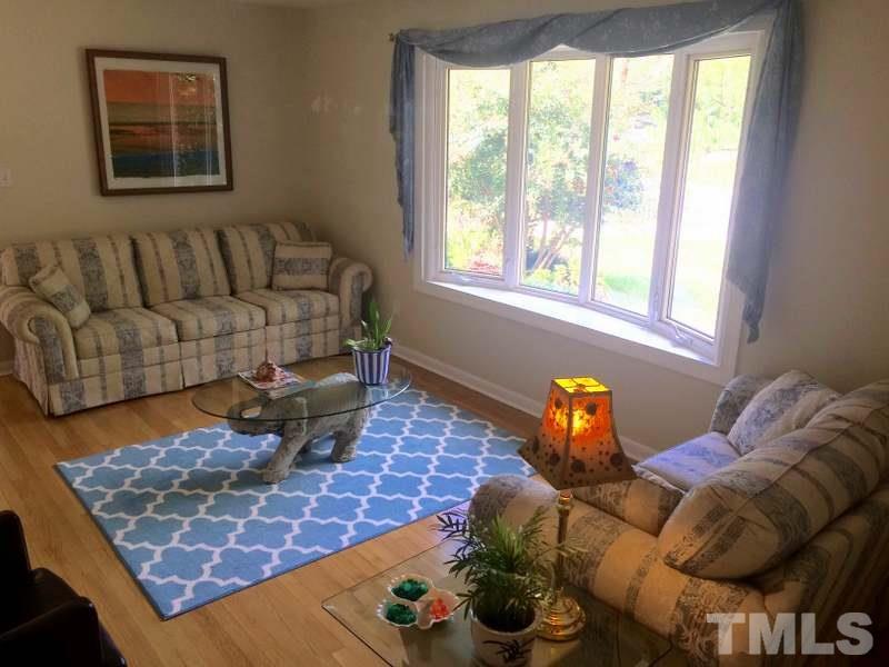 400 Compton Road Raleigh, NC 27609 - Photo 11 of 25 a living room with furniture and a floor to ceiling window