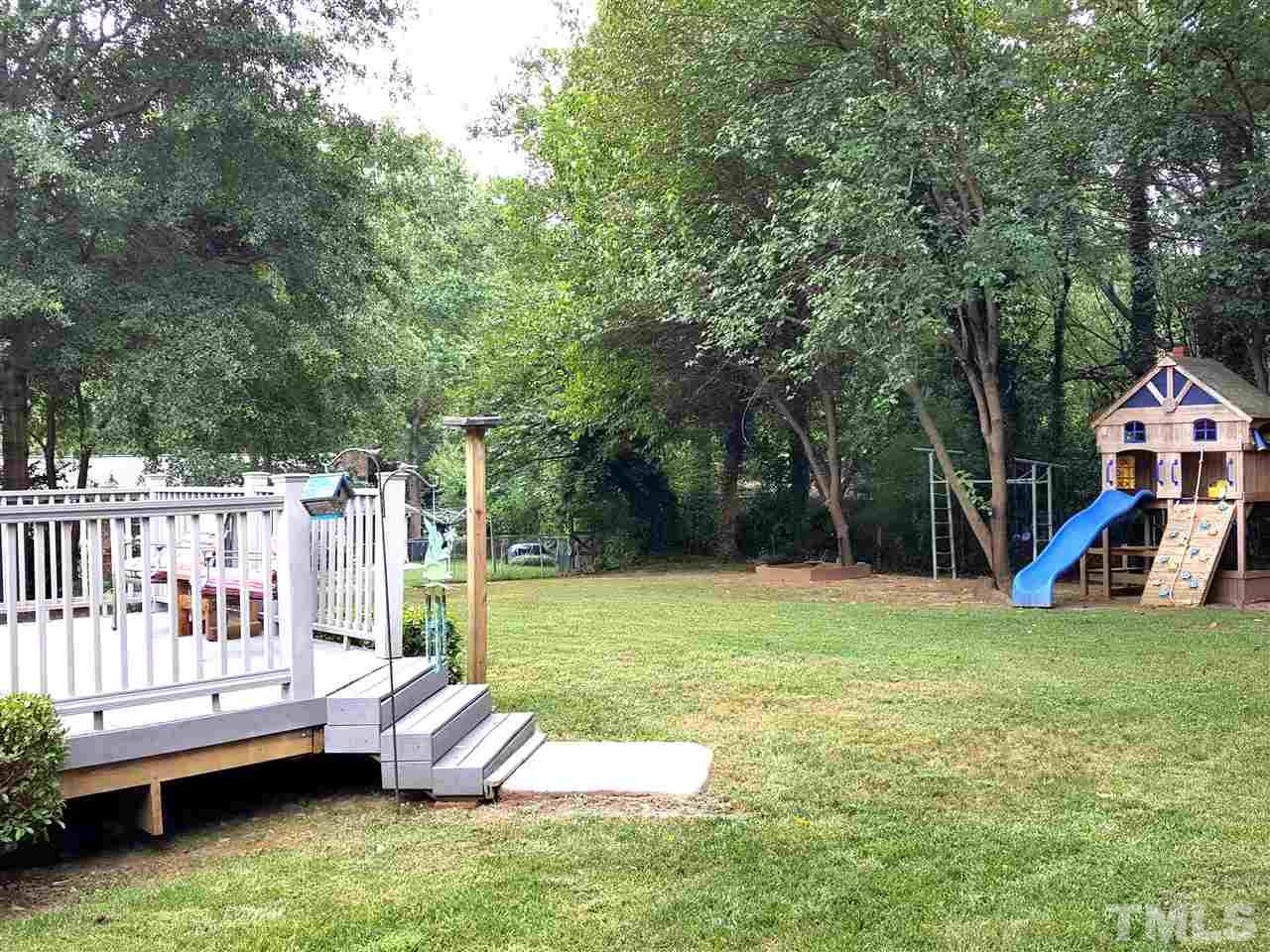 400 Compton Road Raleigh, NC 27609 - Photo 14 of 25 a view of a house with a backyard and a slide