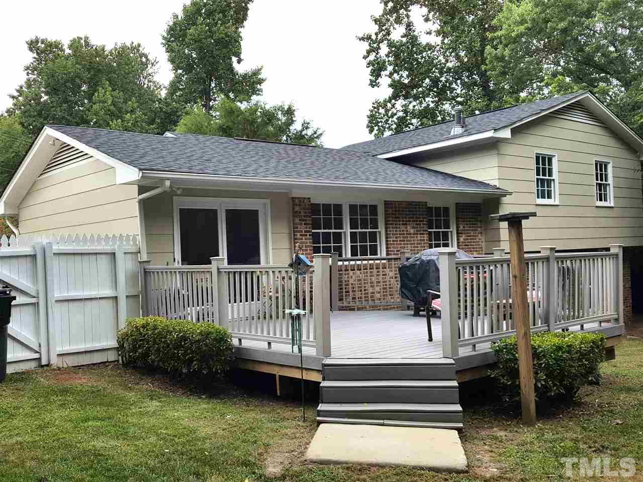 400 Compton Road Raleigh, NC 27609 - Photo 15 of 25 a view of a house with a small yard and wooden fence